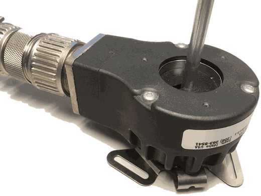 A rotary incremental encoder with a shaft and connector