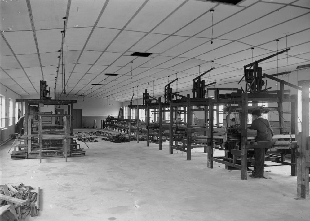 Textile machinery with rolls of woven fabric at a mill